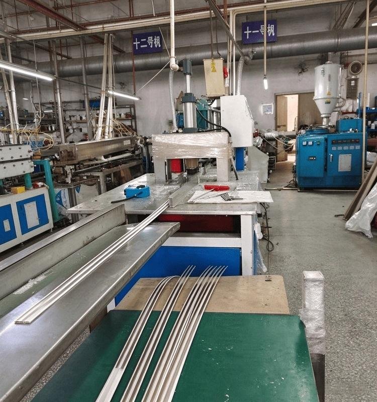 A long, continuous co-extruded conductive profile being manufactured on an extrusion line.